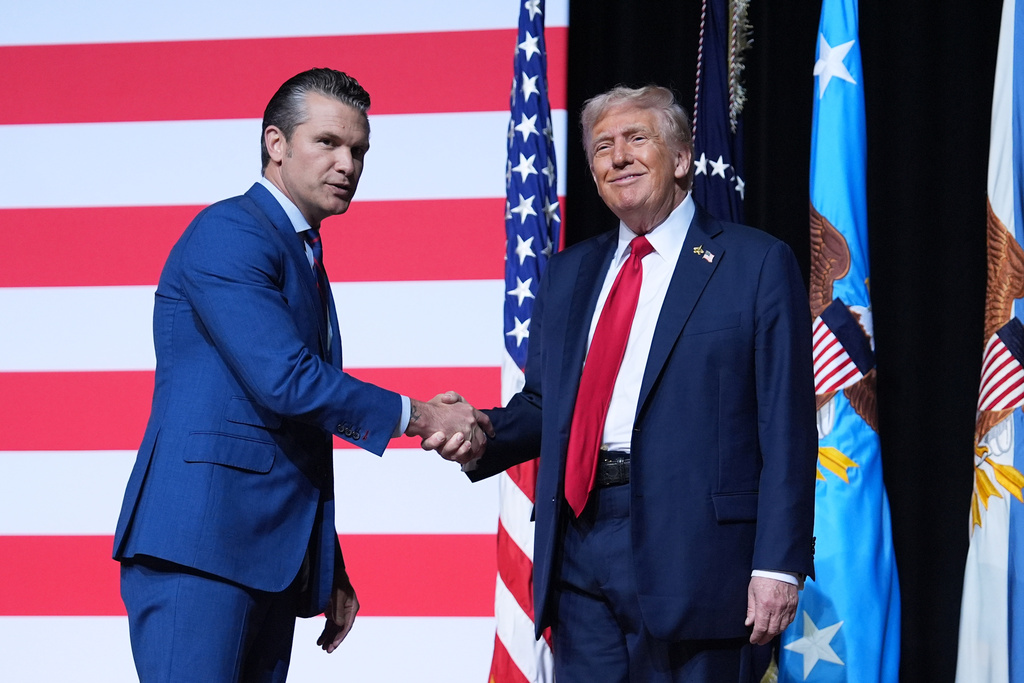 President Donald Trump is greeted by Secretary of Defense Pete Hegseth before speaking to a gathering of top U.S. military commanders at Marine Corps Base Quantico, Tuesday, Sept. 30, 2025, in Quantico, Va. 