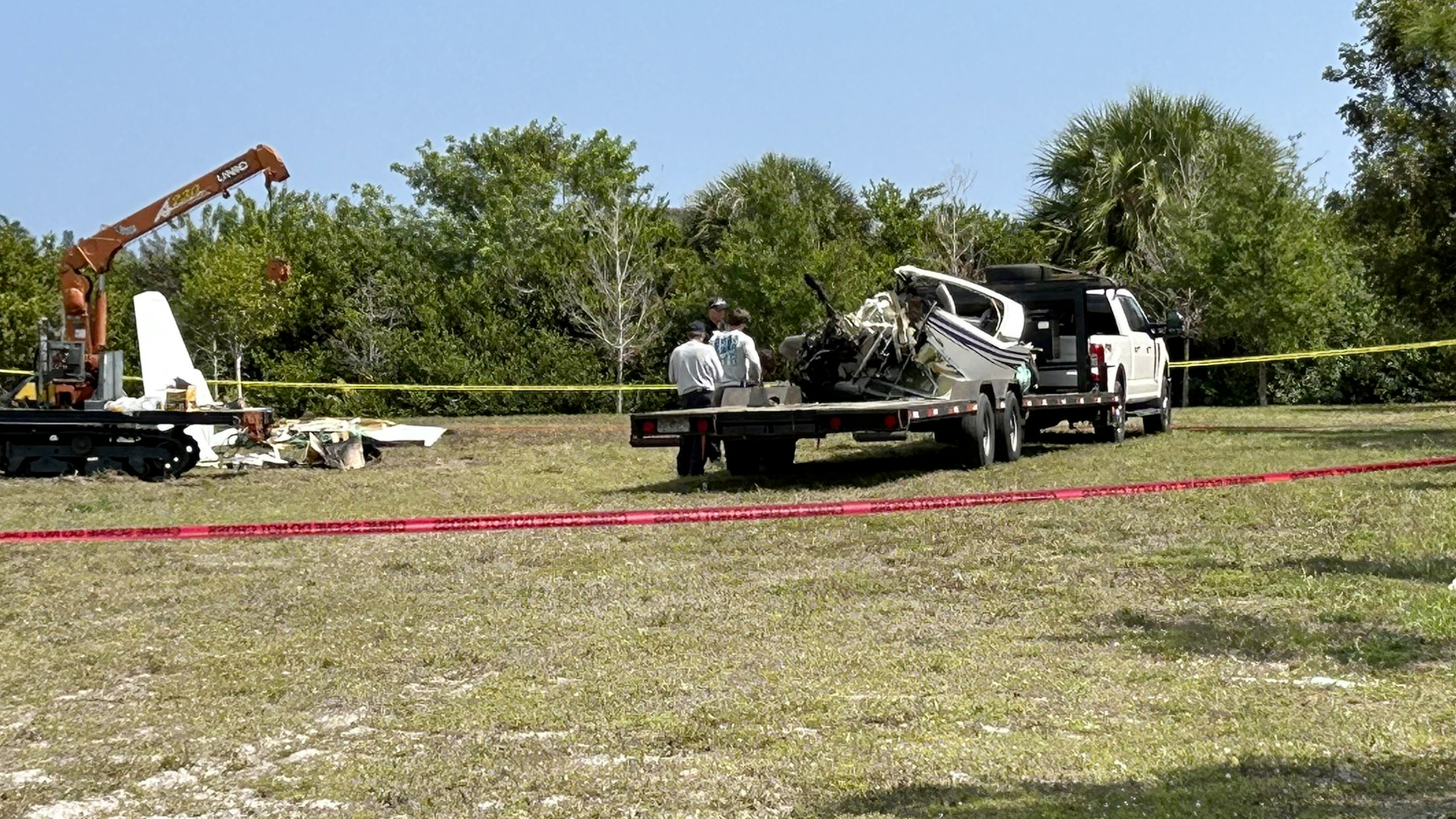 The Diamond DA40 plane that crashed near Palm Beach County Park Airport Sunday night was towed away Tuesday from the field it crashed on.