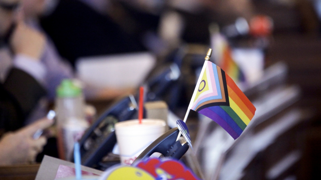 A flag supporting LGBTQ+ rights is shown.