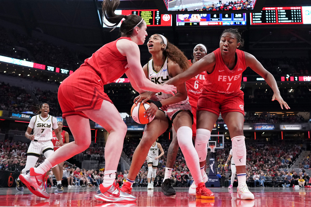 Indiana Fever guard Caitlin Clark, left, fouls Chicago Sky forward Angel Reese, center, during the second half an WNBA basketball game in Indianapolis, Saturday, May 17, 2025. 
