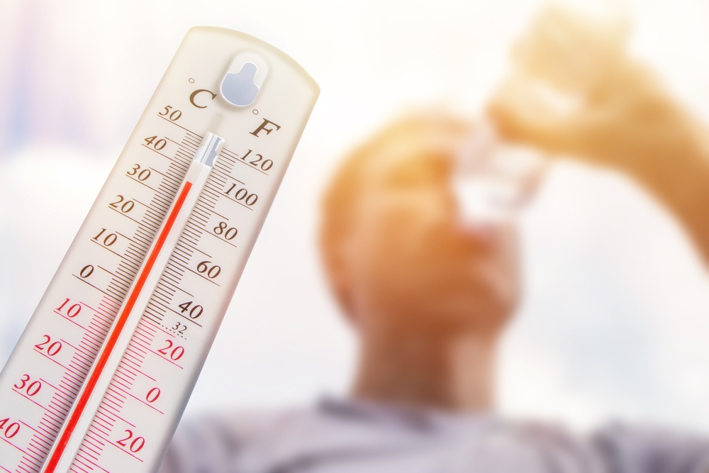 Man is drinking water in extreme heat.