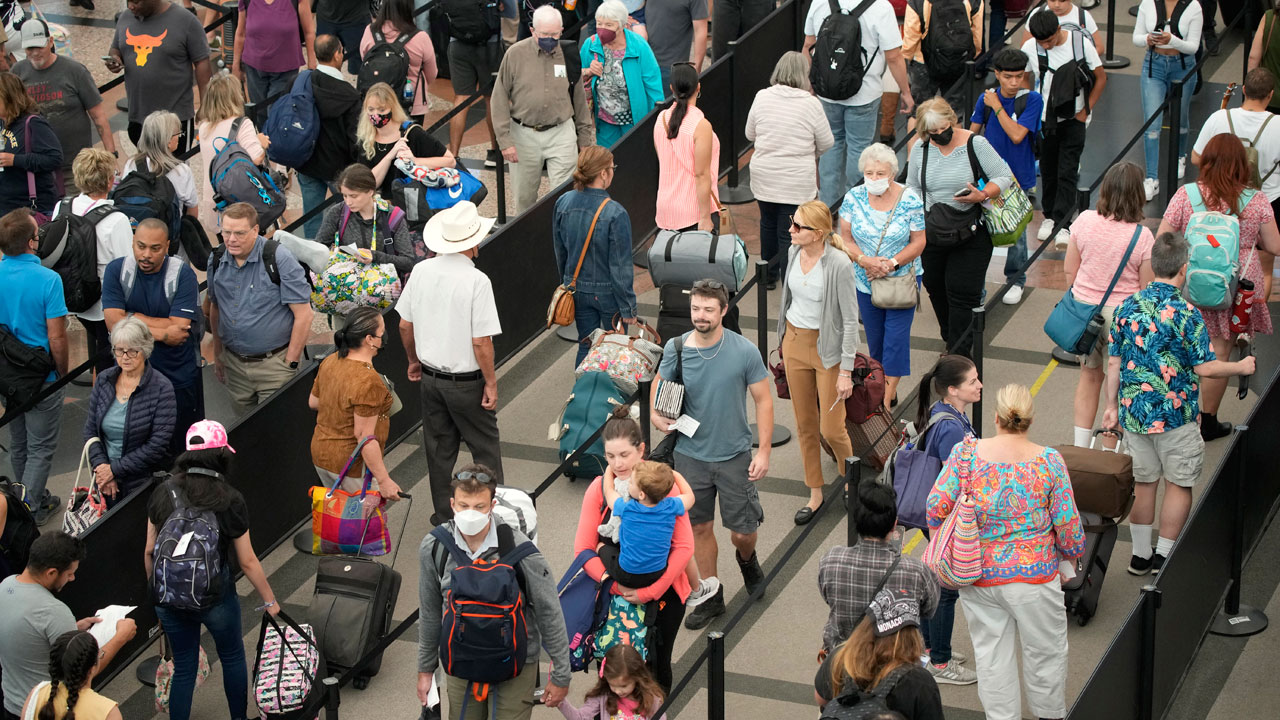 Travelers queue up at the south security checkpoint in Denver International Airport as the Labor Day holiday approaches Tuesday, Aug. 30, 2022, in Denver. 
