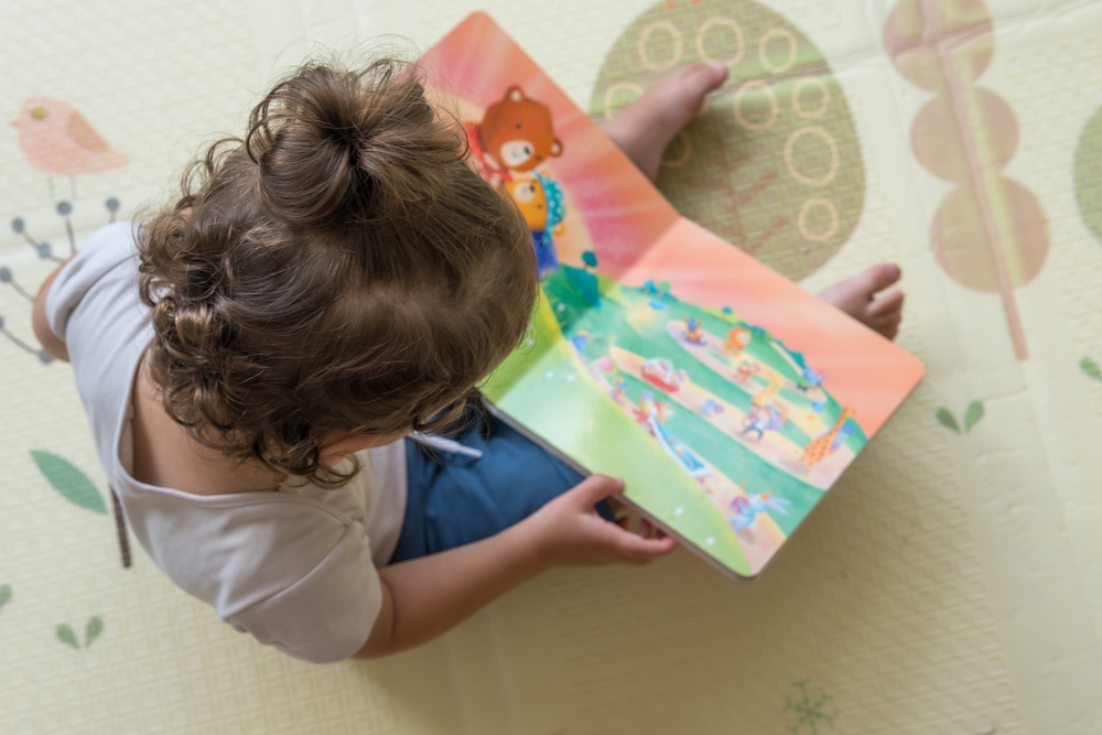 Toddler reading a book