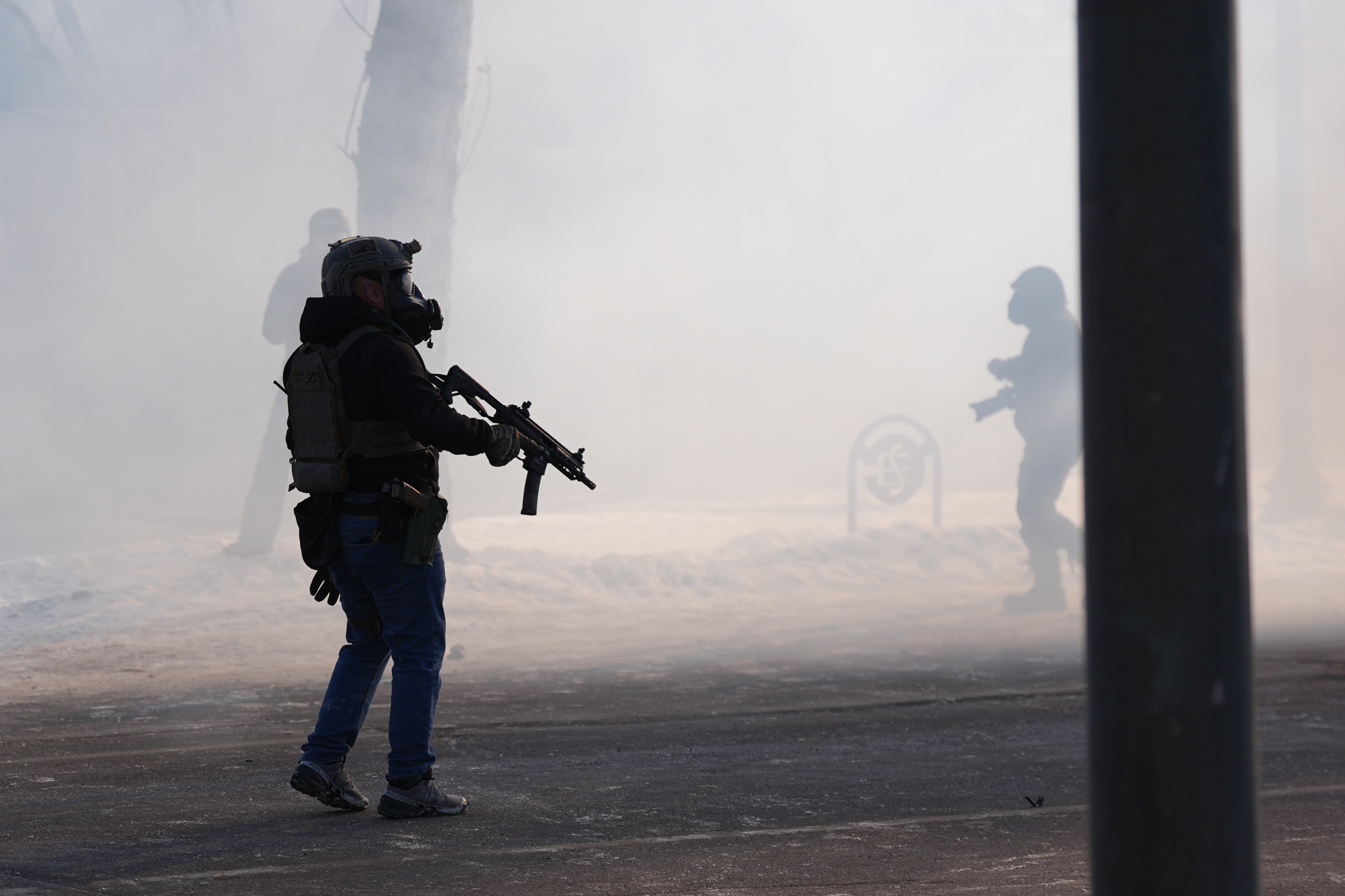 Federal immigration officers deploy tear gas at observers after a shooting Saturday, Jan. 24, 2026, in Minneapolis. 