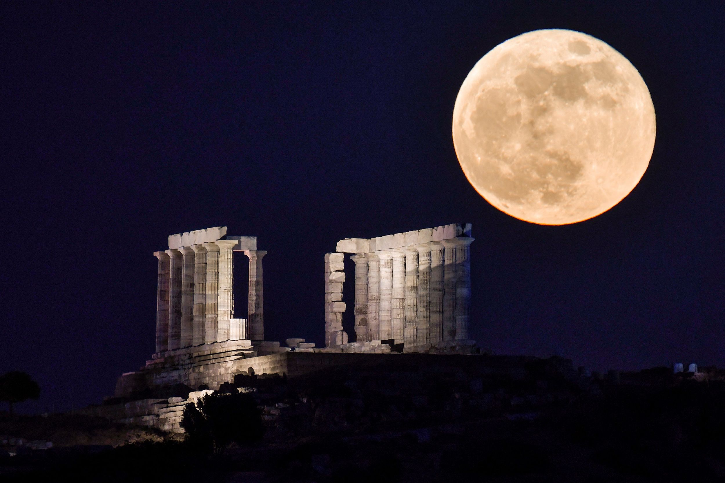 May flower moon
Caption:	A full flower moon rises behind the Temple of Poseidon at Cape Sounion, Greece, in May 2021.
Mandatory Credit:	Louisa Gouliamaki/AFP/Getty Images via CNN Newsource