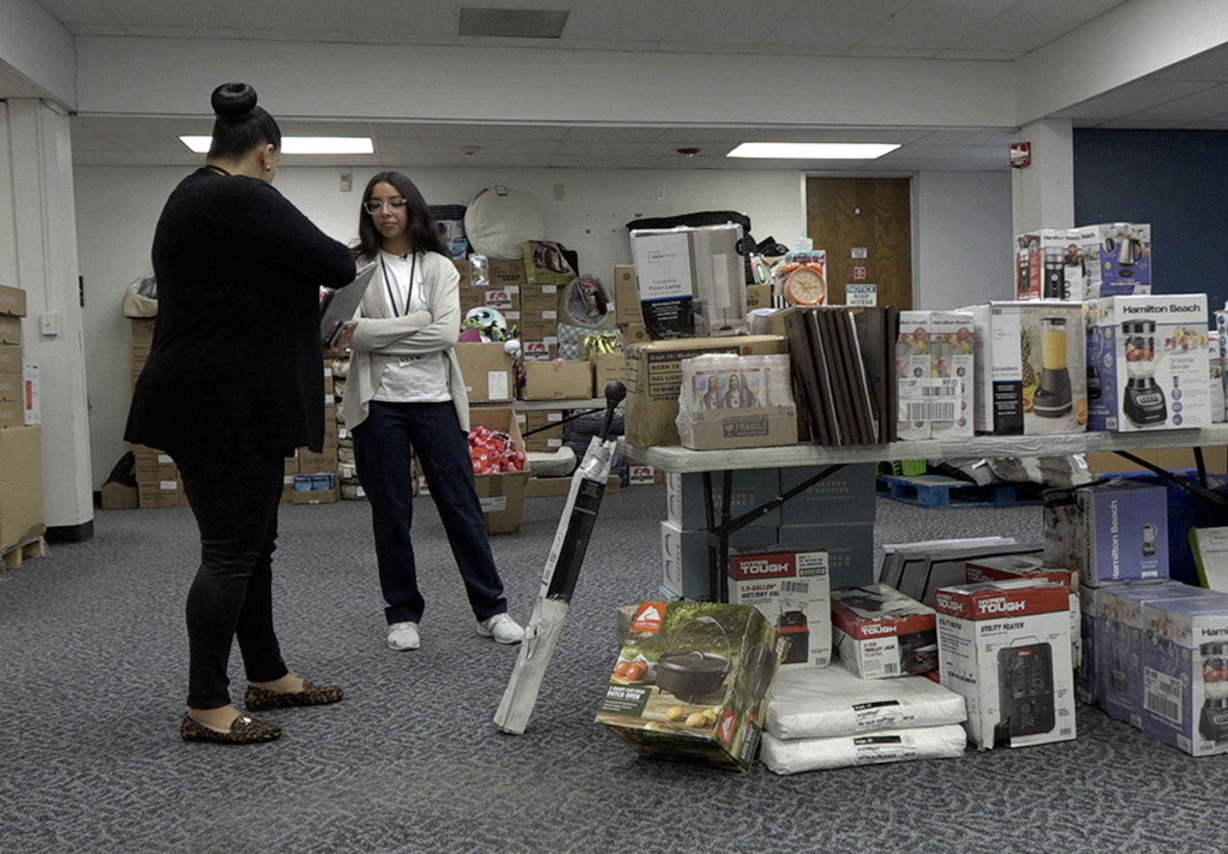 Flood victims helping other victims at new warehouse 