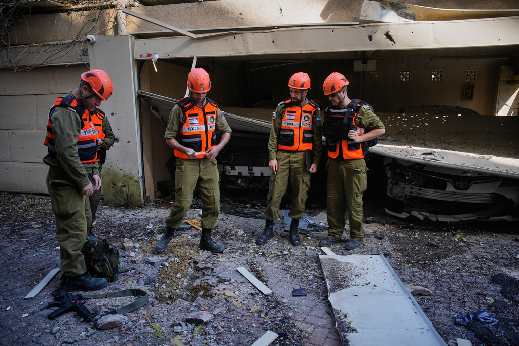 Officers from Israel's Home Front Command inspect a damaged house following an Iranian missile strike in Petah Tikva, Israel, Tuesday, March 3, 2026. 