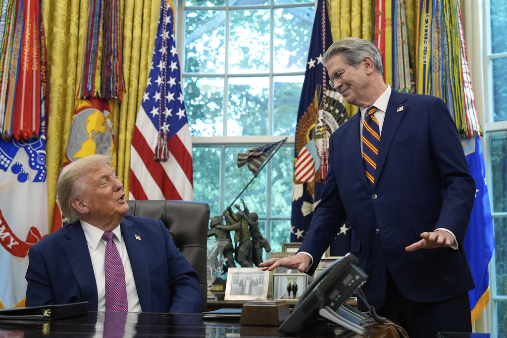 Treasury Secretary Scott Bessent gestures as President Donald Trump speaks in the Oval Office of the White House.