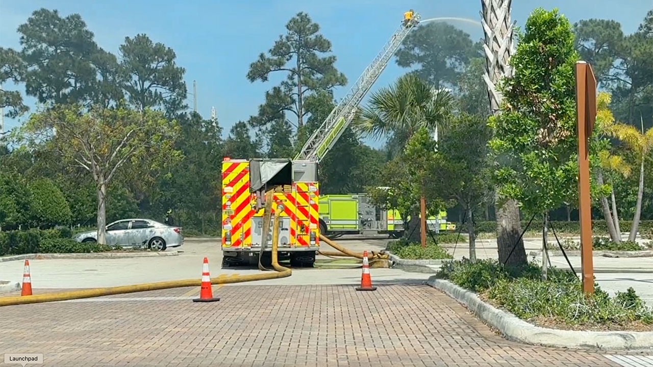A brushfire broke out May 10, 2026, in a wooded area just feet from homes and the Alton Town Center shopping center on Donald Ross Road in Palm Beach Gardens.