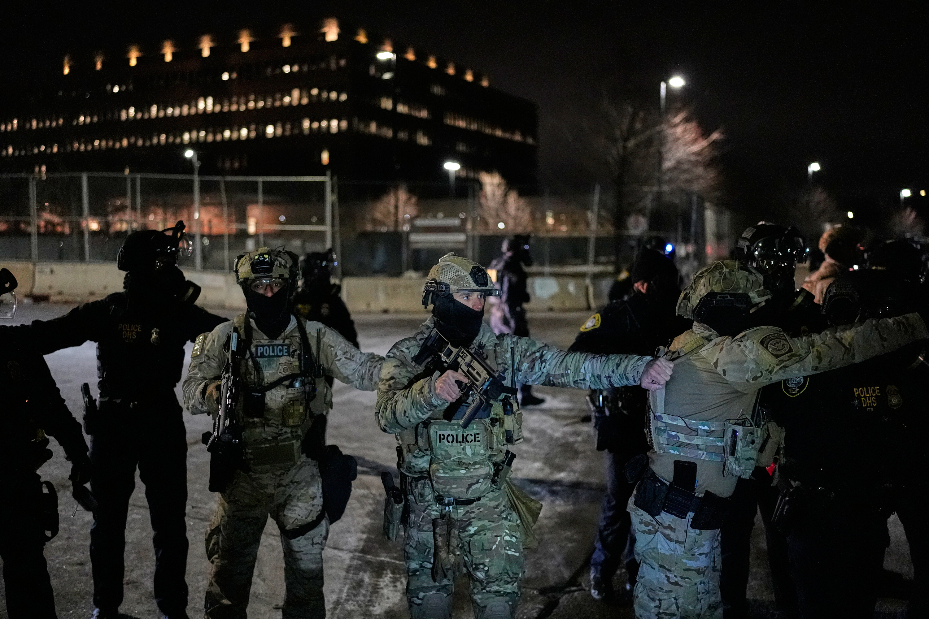 Federal immigration officers confront protesters outside Bishop Henry Whipple Federal Building, Thursday, Jan. 15, 2026, in Minneapolis. 