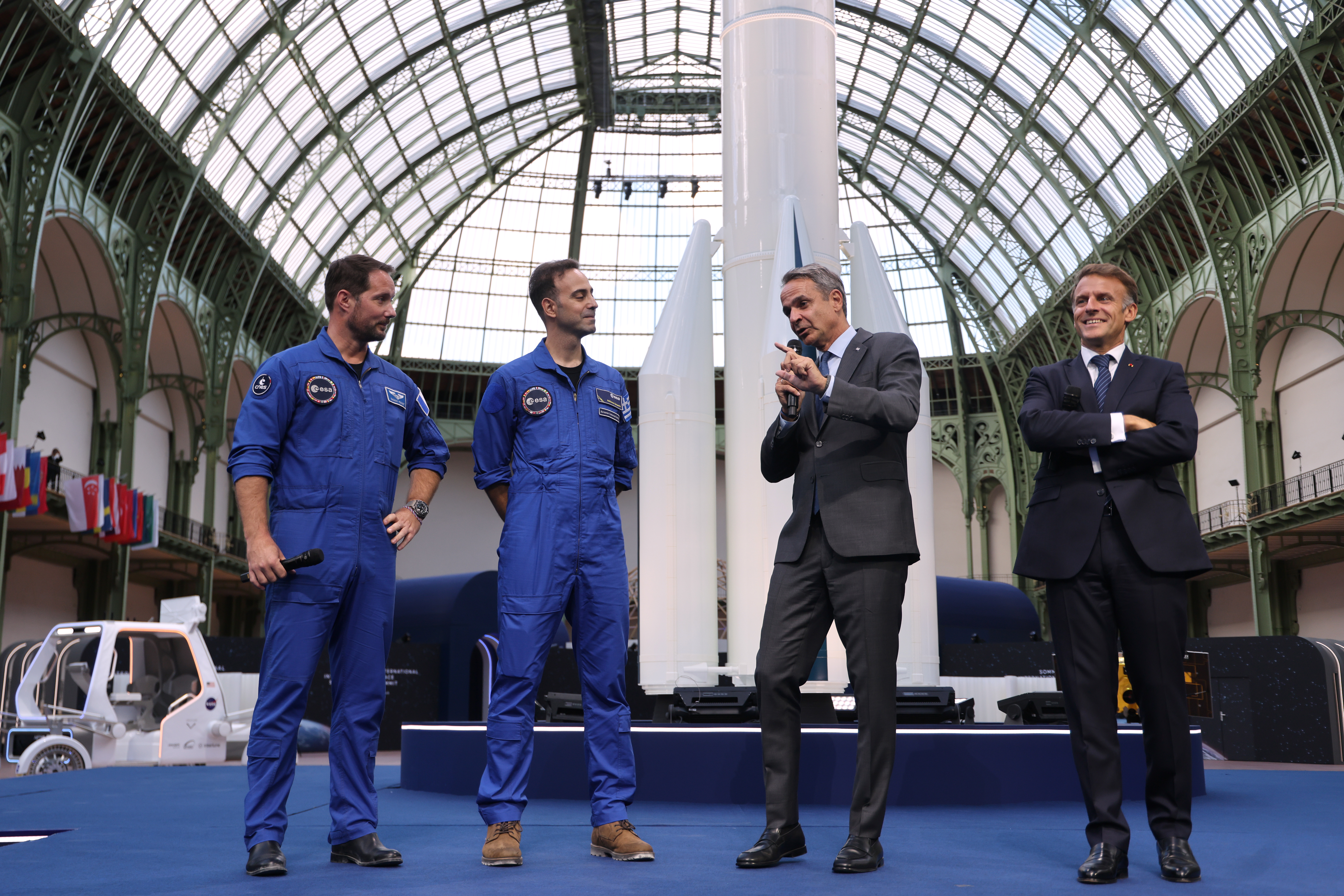 From left, French European Space Agency astronaut Thomas Pesquet, Greek aviation medical examiner and European Space Agency astronaut candidate Adrianos Golemis, Greece's Prime Minister Kyriakos Mitsotakis and Frence President Emmanuel Macron speak during the International Space Summit at the Grand Palais in Paris, Sept. 9, 2026.