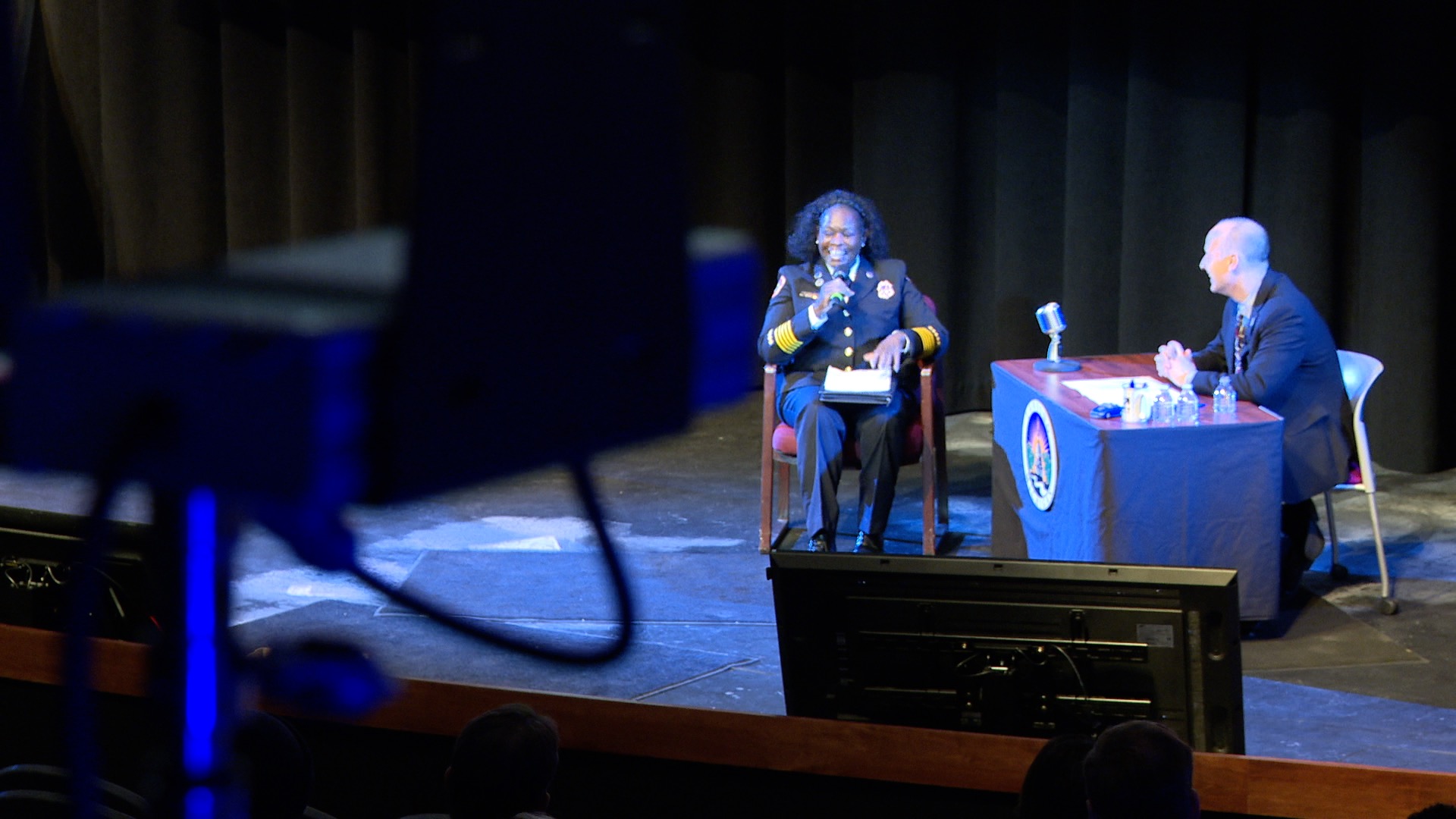 Lansing Mayor Andy Schor speaks with Fire Chief Carrie Edwards-Clemons during State of the City Address