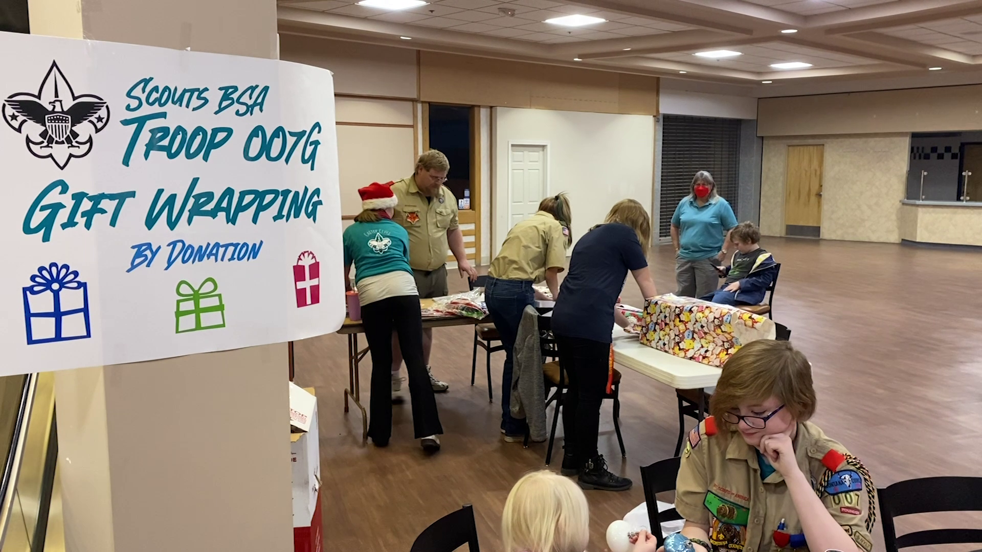 Scouts wrapping gifts in Great Falls