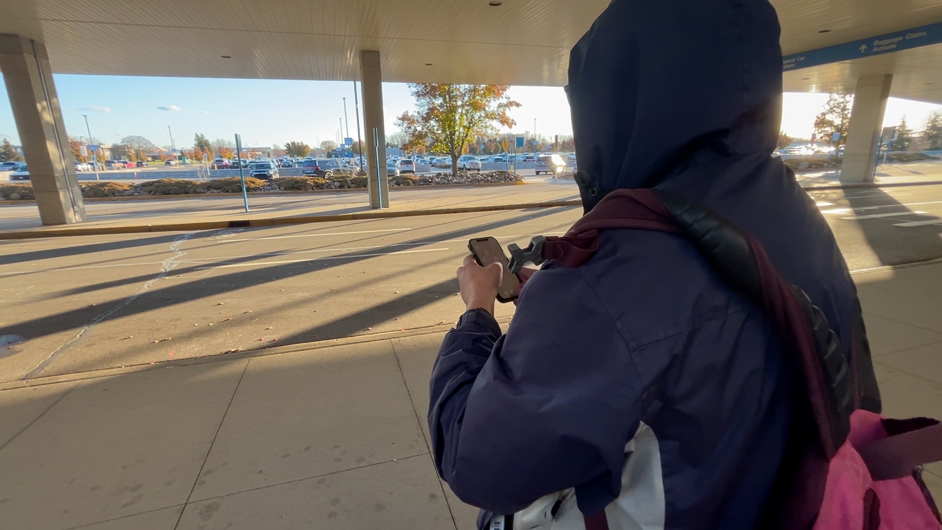 Dawson White waits for bus at Lansing airport