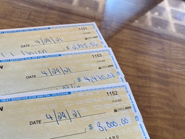 Denver7 Gives checks for Merithew Family bills