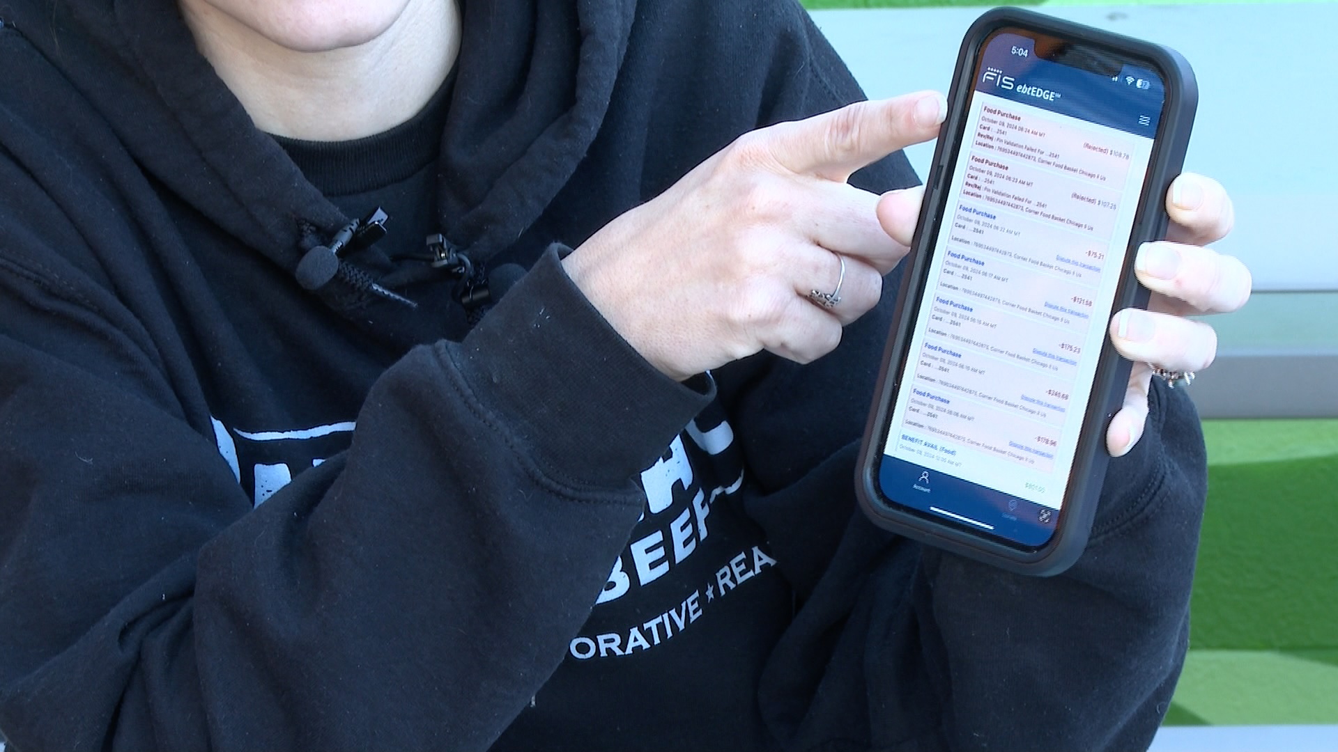 Woman shows profile on mobile app of stolen SNAP benefits 