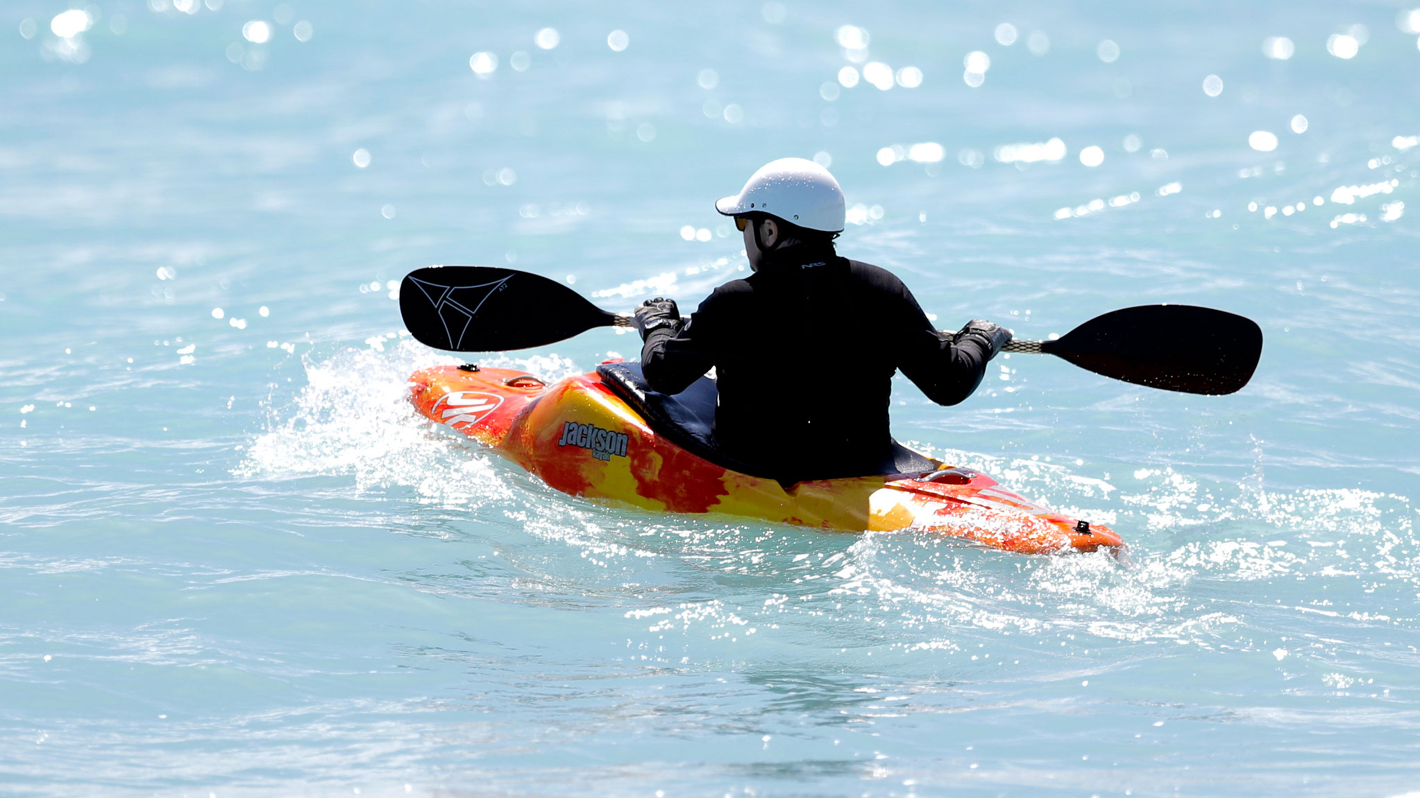 A kayaker battles the surf while paddling at Jupiter Beach Park, Tuesday, March 17, 2020, in Jupiter, Fla.