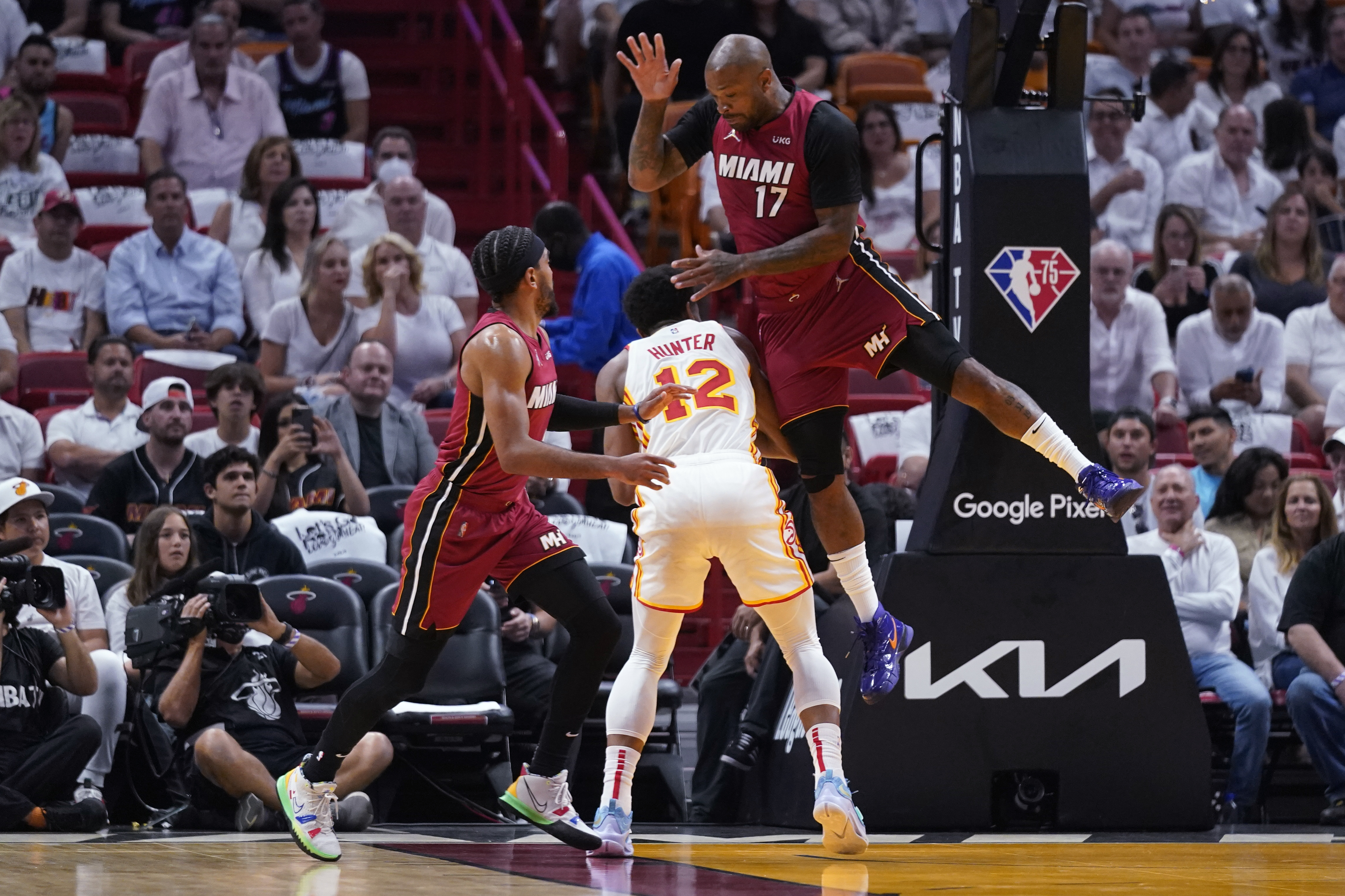 Atlanta Hawks forward De'Andre Hunter attempts shot against Miami Heat guard Gabe Vincent and forward P.J. Tucker, April 26, 2022