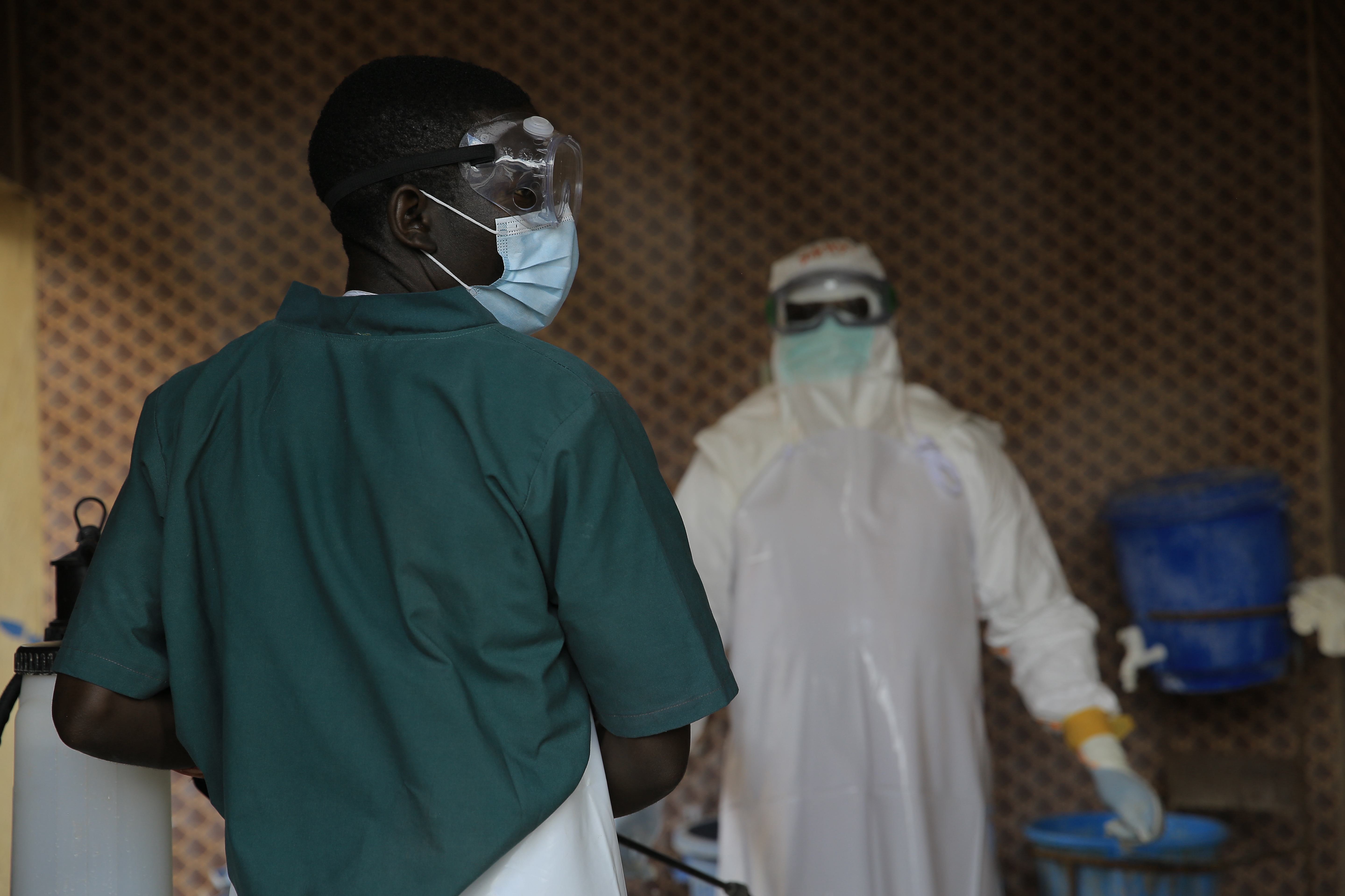 A healthcare worker is disinfected by his colleague inside a treatment center for Ebola patients in Beni, North Kivu province, eastern Congo, Saturday, Sept. 26, 2026. 