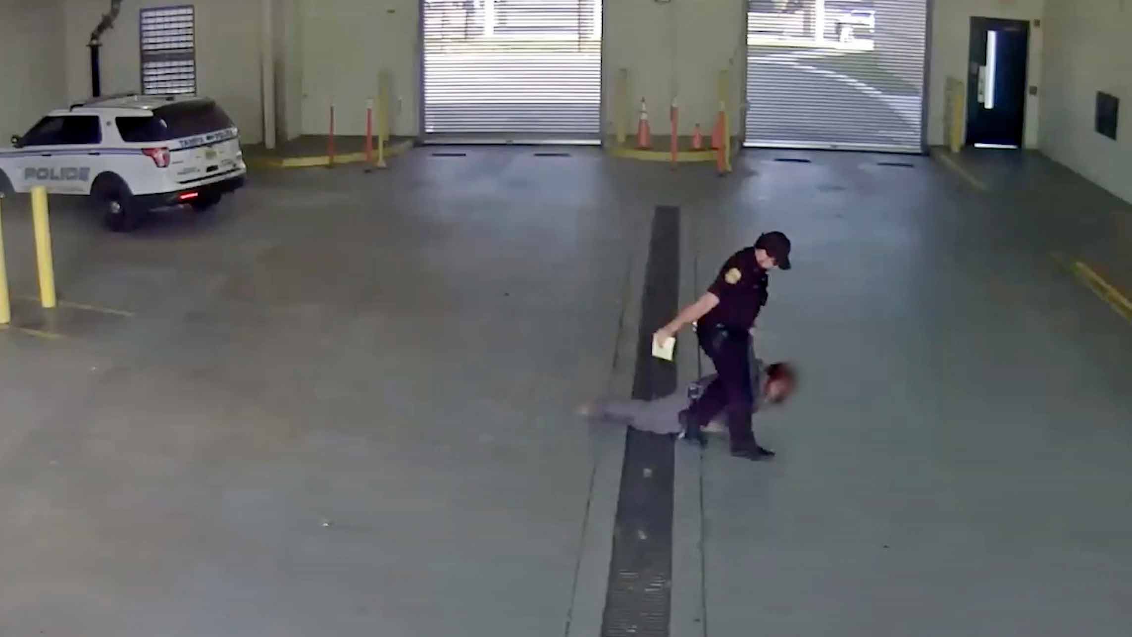 In this image taken from a video released by the Tampa Police Department, police officer Gregory Damon drags a woman across the floor at Orient Road Jail in Tampa, Fla., on Nov. 17, 2022. Damon, who was videotaped dragging a handcuffed woman on the floor has been fired, authorities said. An internal investigation determined that the former officer violated department policies during the Nov. 17 incident, the Tampa Police Department announced Tuesday, Dec. 27, 2022, in a news release. 