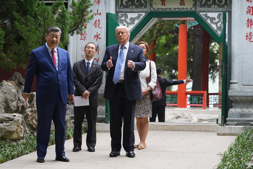 President Donald Trump walks with China's President Xi Jinping at the Zhongnanhai leadership compound, Friday, May 15, 2026, in Beijing.