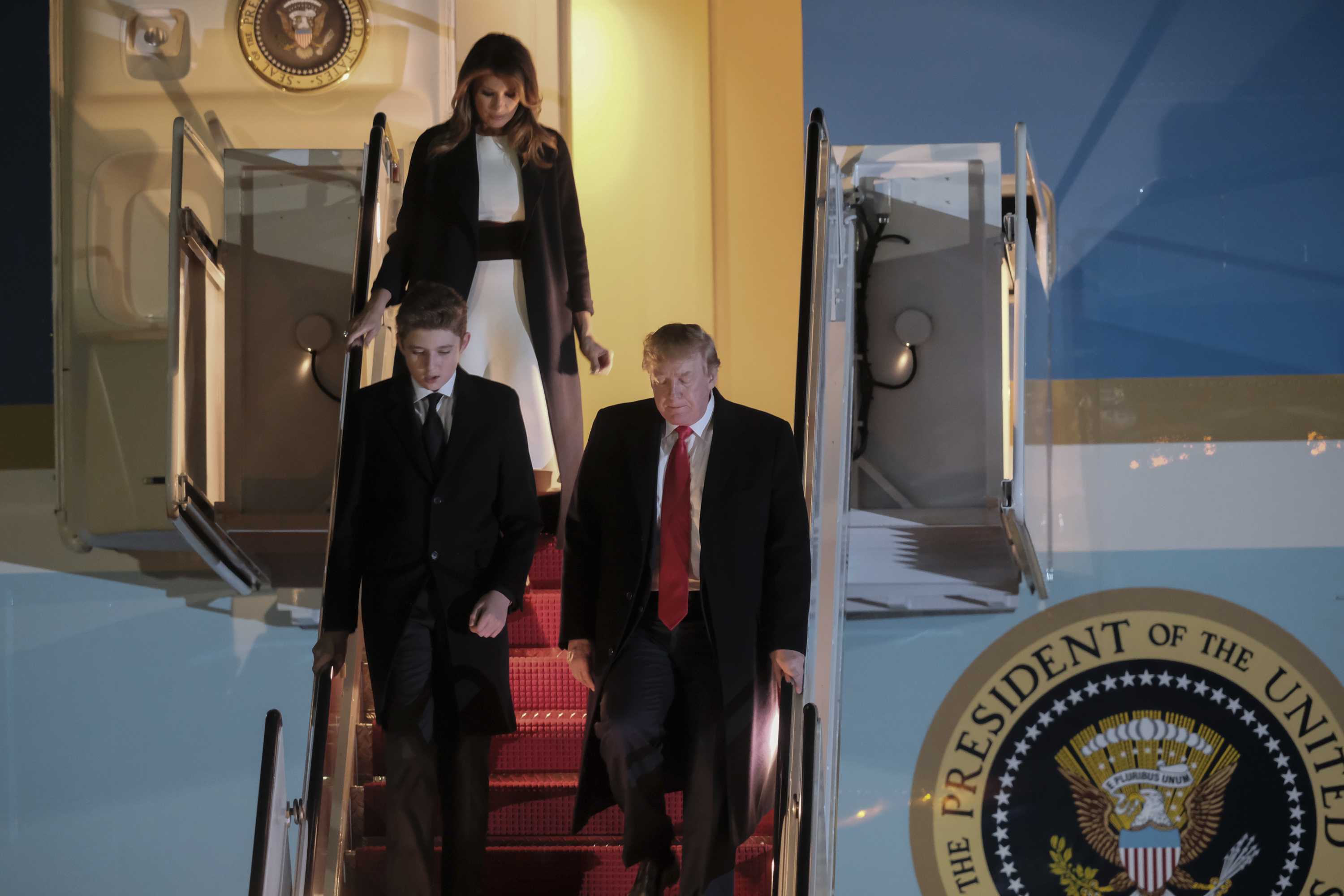 Baron Trump, Melania Trump and Donald Trump walk off Air Force One in February 2020