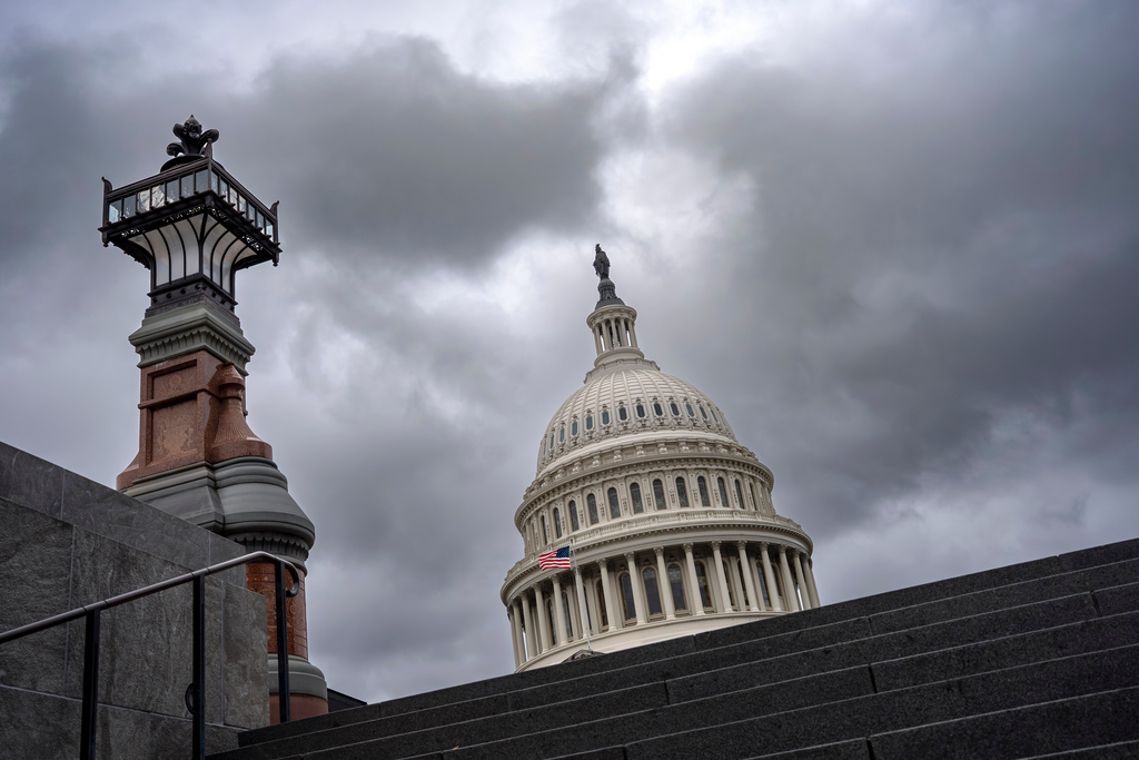 The Capitol is seen under gray skies on the thirteenth day of the government shutdown, in Washington, Monday, Oct. 13, 2025. 