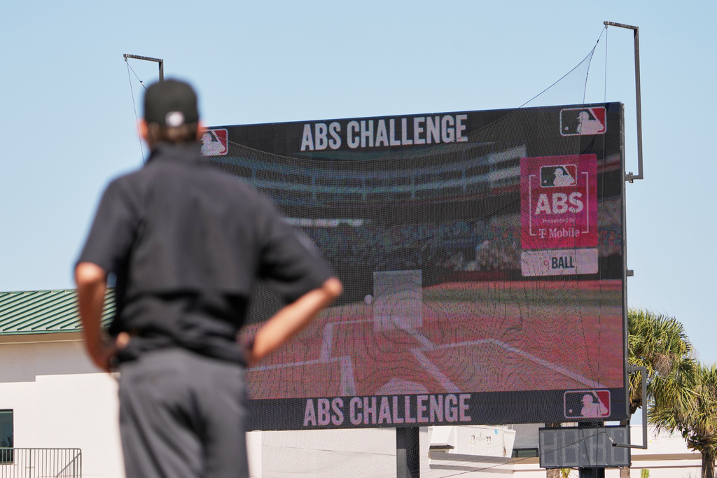 Umpire Ryan Additon watches as a call is challenged using MLB's ABS challenge system during the third inning of a spring training baseball game between the Miami Marlins and the Houston Astros Wednesday, Feb. 25, 2026, in Jupiter, Fla.