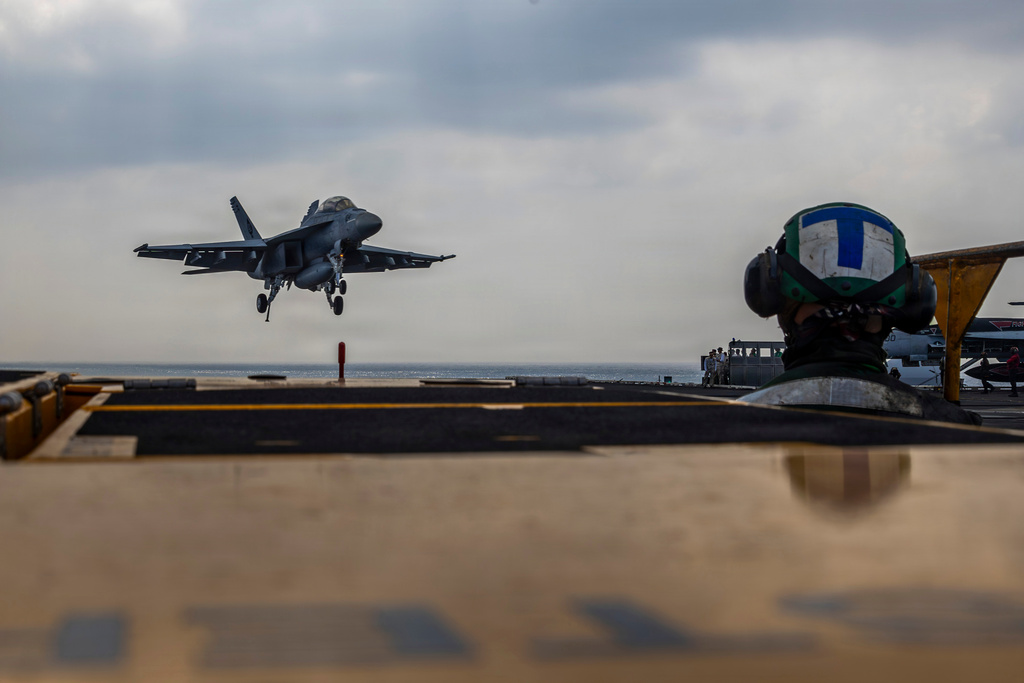 This photo provided by the U.S. Navy shows a Boeing F/A-18E Super Hornet landing on the Nimitz-class aircraft carrier USS Abraham Lincoln in the Indian Ocean on Jan. 22, 2026. 