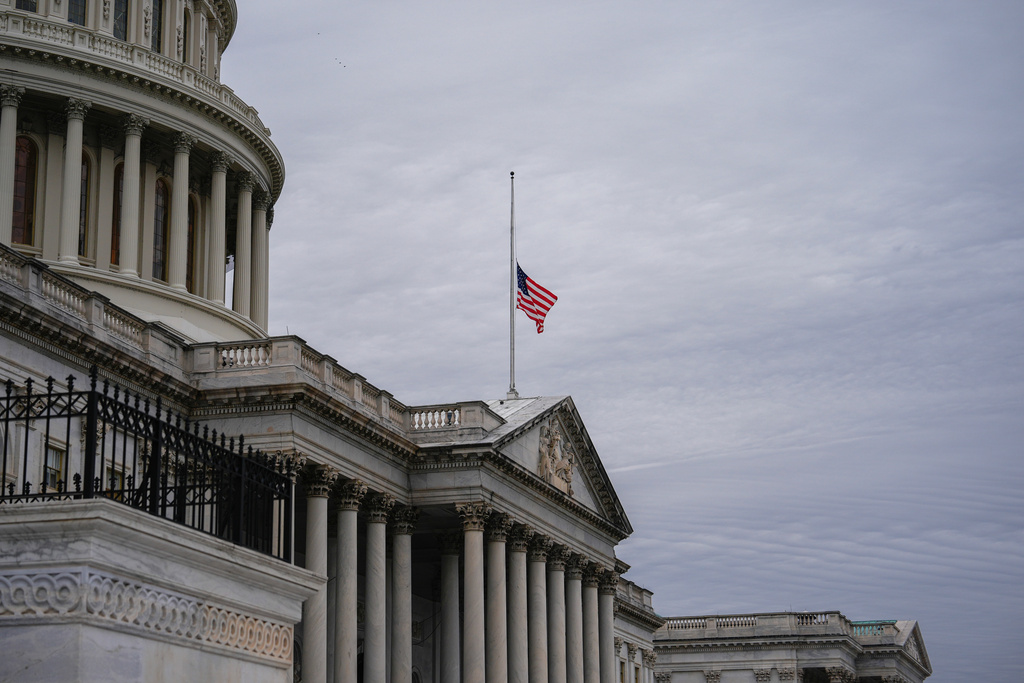 The American flag flies half-staff outside the U.S. Capitol, Tuesday, Nov. 18, 2025, in Washington.