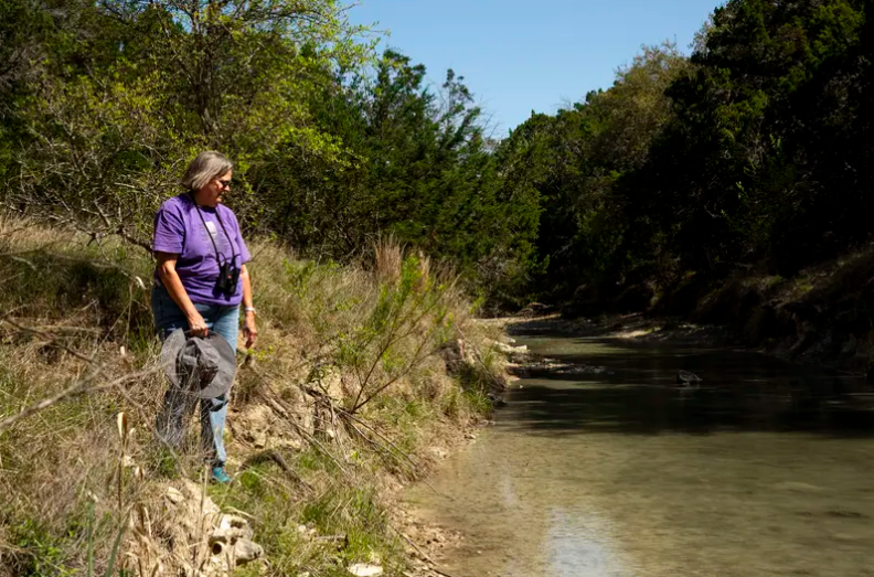 Margo Denke, co-founder of the group Friends of Hondo Canyon, surveys a stretch of Commissioners Creek on her ranch in Bandera County. 