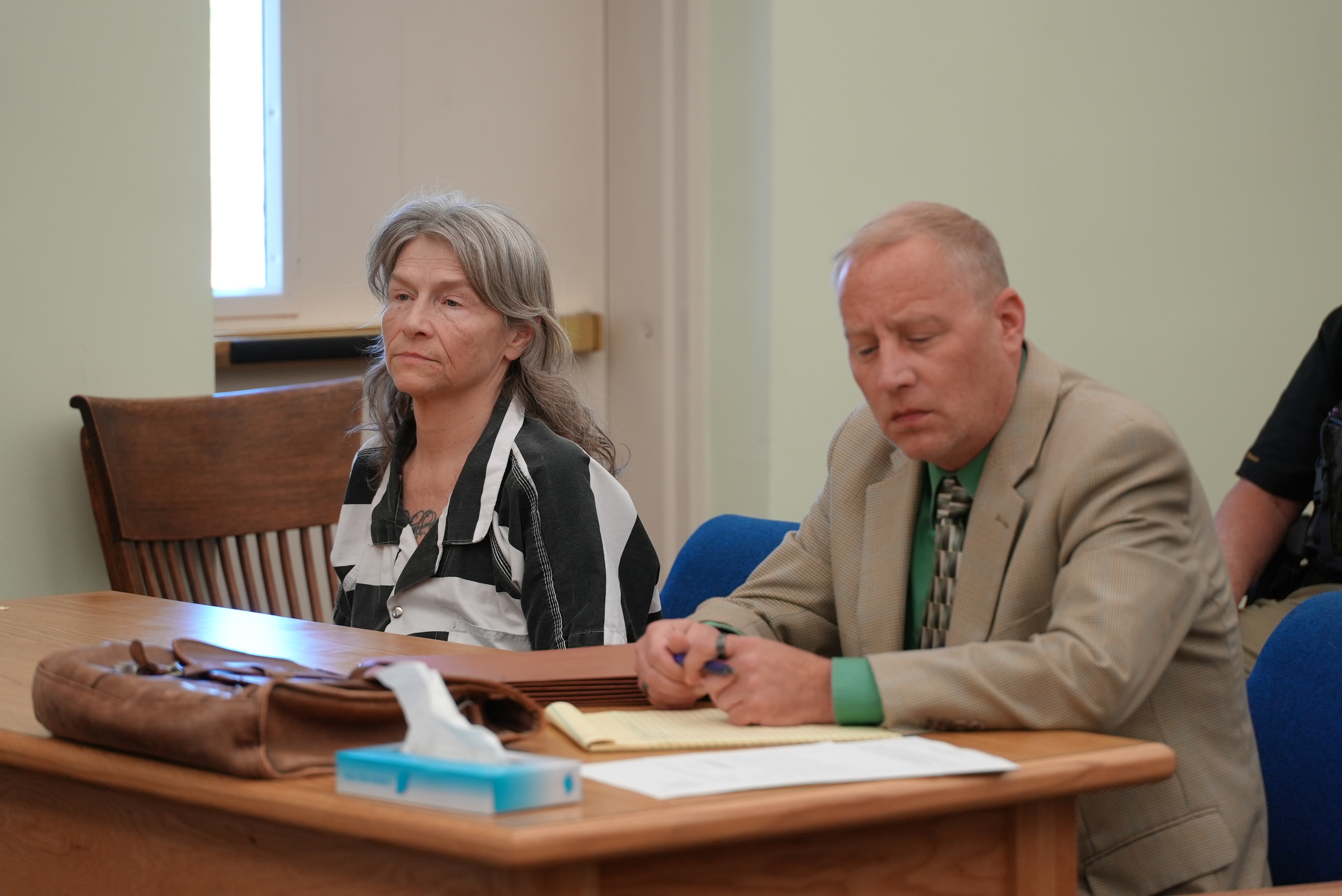 Dianna Lewis sitting by her attorney 
