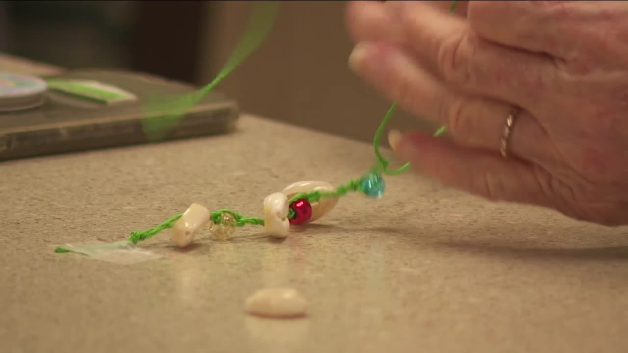 Senior citizens make puka shells for Maui.jpg