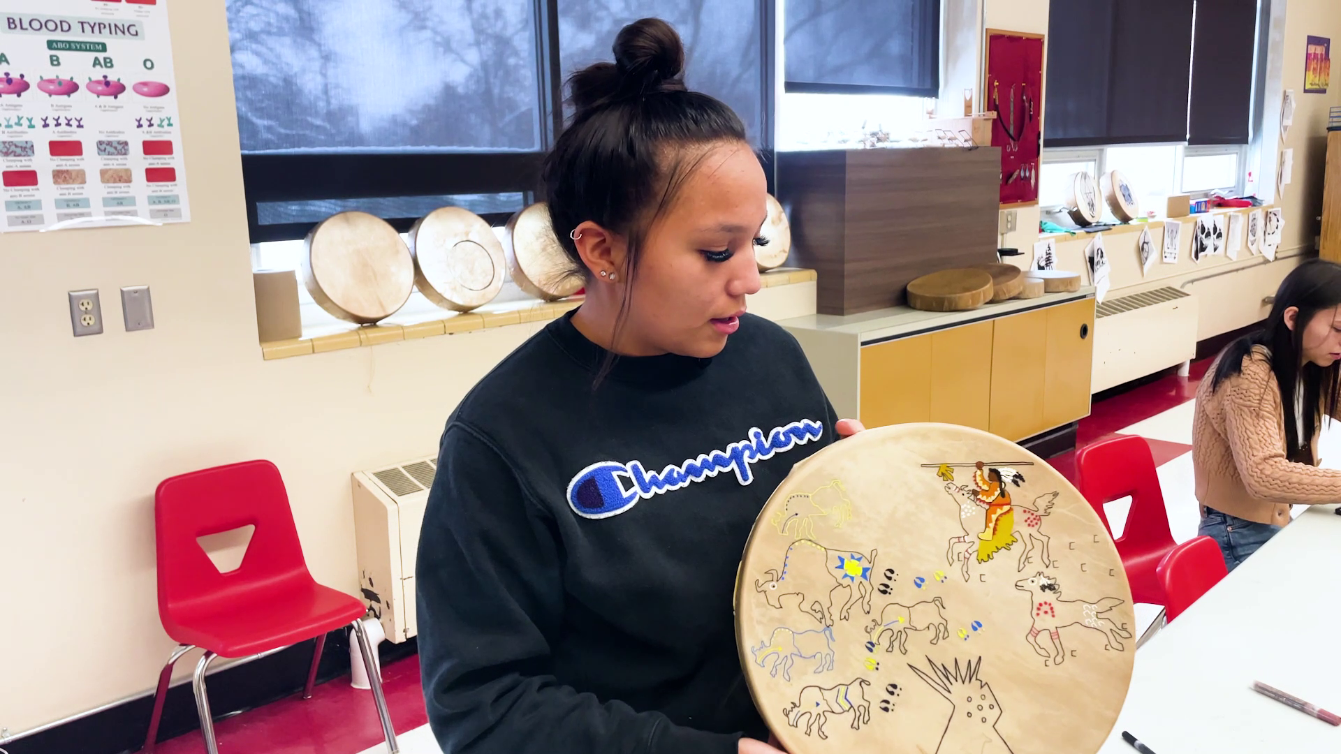 Students at Paris Gibson Education Center are painting bison hides for drums to learn about culture and history