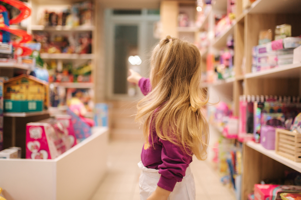 Stock image of a young girl inside a toy store.