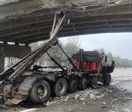 Truck hits overpass
