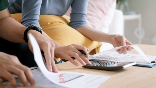 Stock image of young people organizing finances.