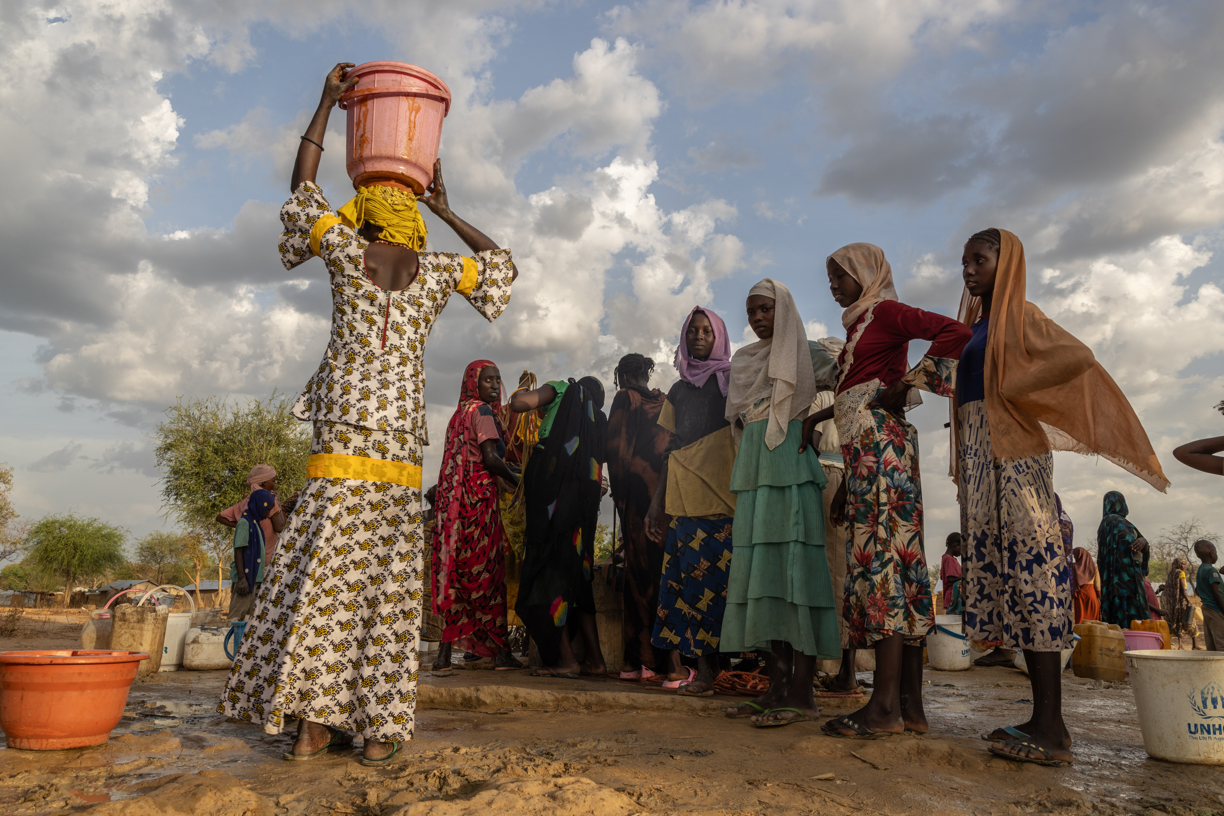 FILE -Women and children fetch water at dusk in the Korsi Refugee Camp in Birao, the Central African Republic, March 27, 2026.