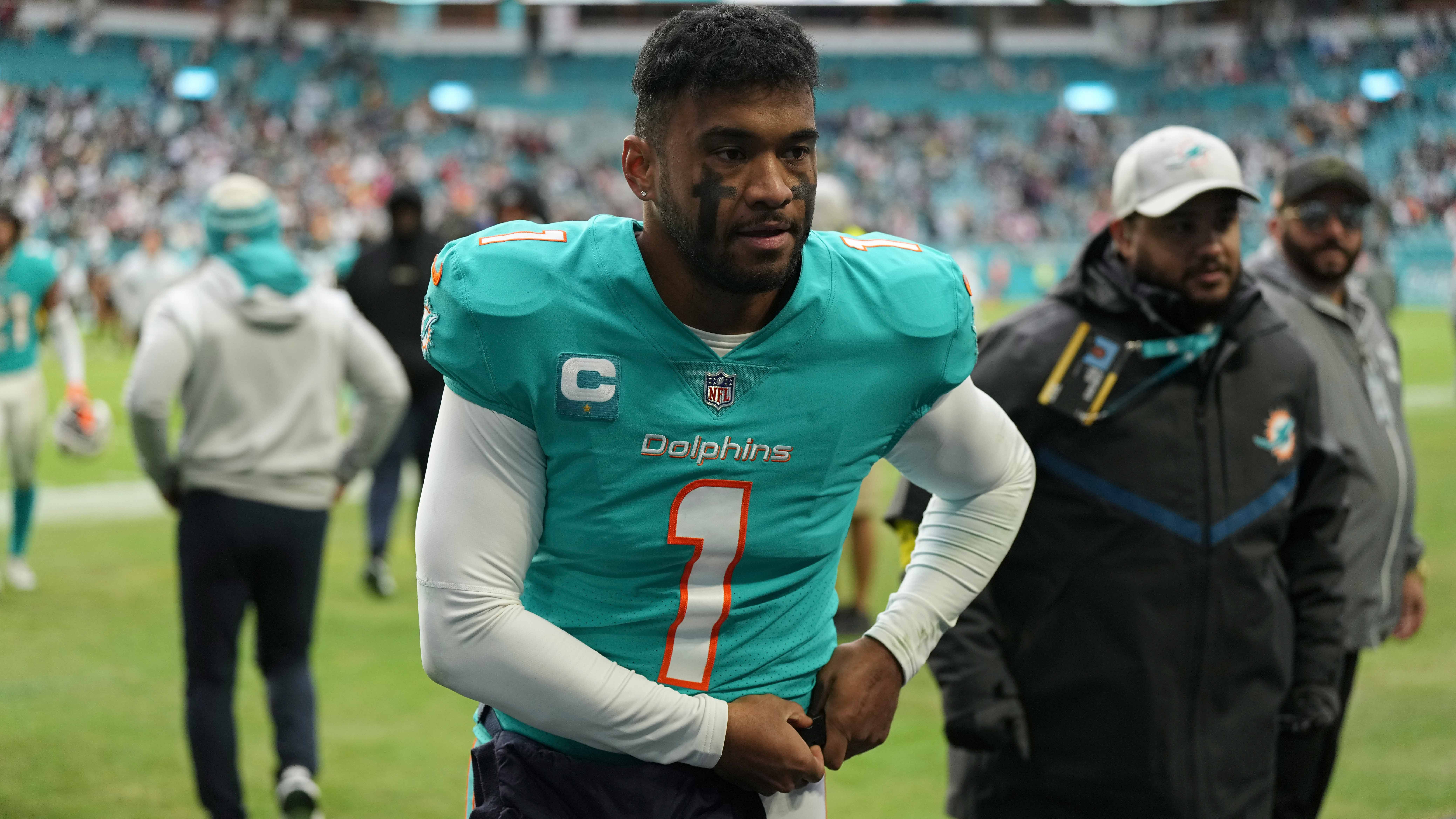 Miami Dolphins quarterback Tua Tagovailoa (1) walks off the field after an NFL football game against the Green Bay Packers, Sunday, Dec. 25, 2022, in Miami Gardens, Fla. Tagovailoa has officially been ruled out for Sunday's game at New England after suffering a concussion in Miami's Christmas Day loss to Green Bay.
