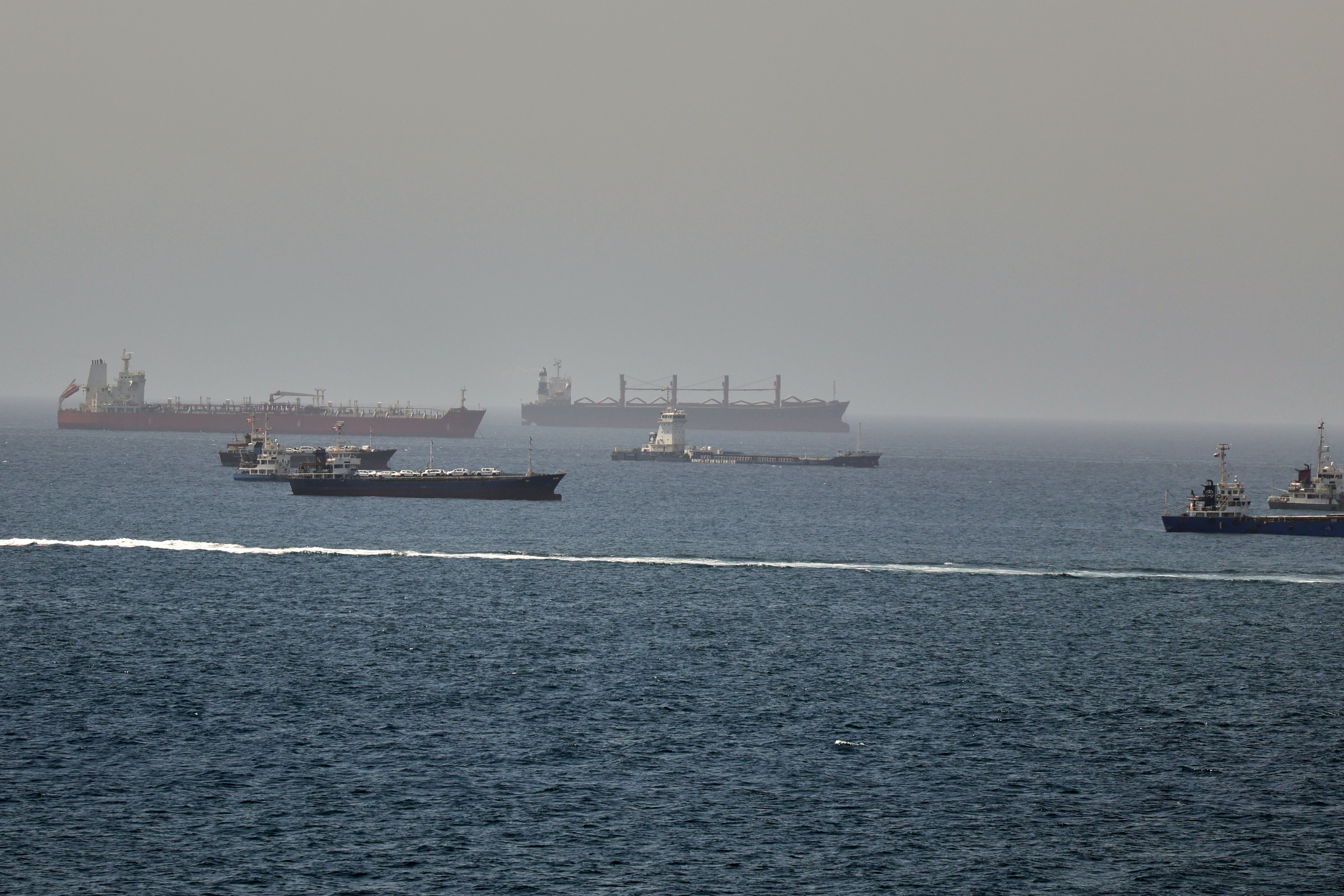 Tankers and cargo vessels are seen in the Gulf of Oman, along shipping routes linking the Strait of Hormuz and the Arabian Sea, Tuesday, June 16, 2026.