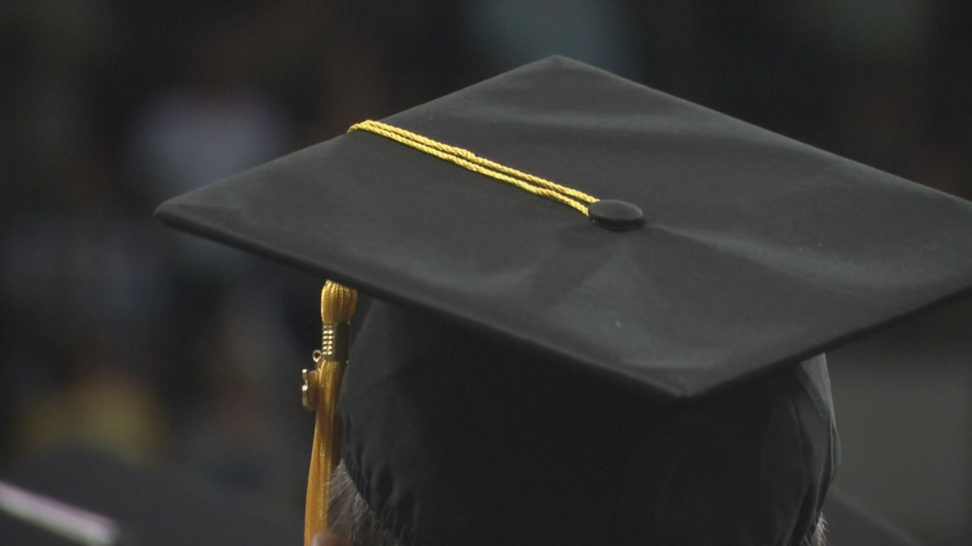 Person wearing graduation cap.