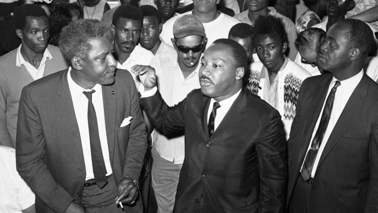 Dr. Martin Luther King Jr. addresses a gathering in the riot-torn area of Los Angeles, Aug. 18, 1965.
