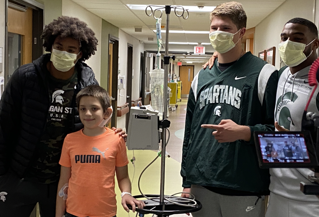MSU football players spread a little joy during visit to Sparrow's Children's Center