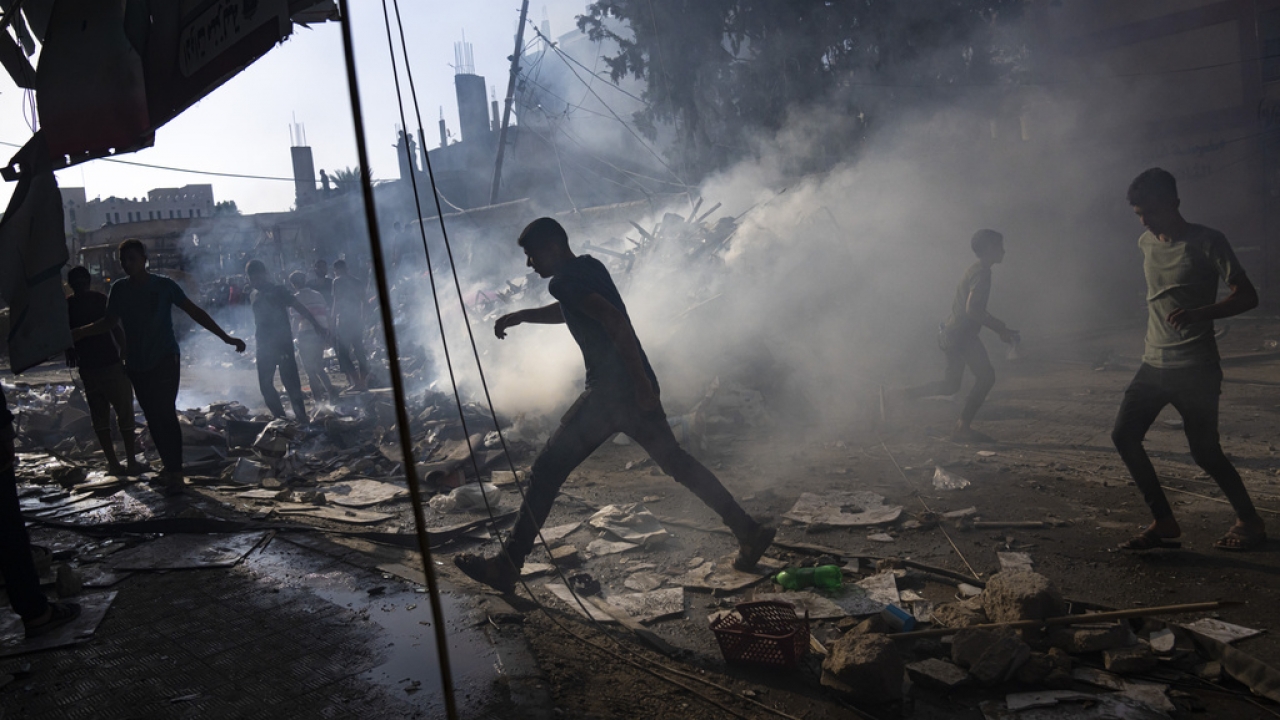 Palestinians look for survivors following an Israeli airstrike in Khan Younis refugee camp, southern Gaza Strip