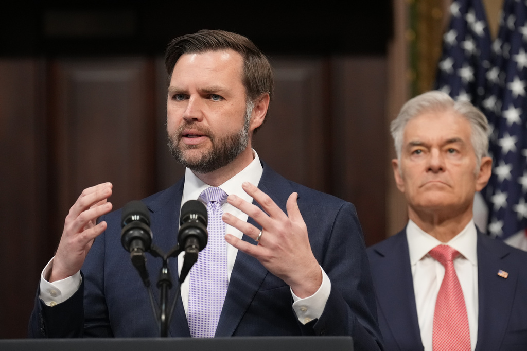 Flanked by Centers for Medicare & Medicaid Services Administrator Dr. Mehmet Oz, right, Vice President JD Vance speaks to the media from the Eisenhower Executive Office Building on the White House campus, Wednesday, May 13, 2026, in Washington. 