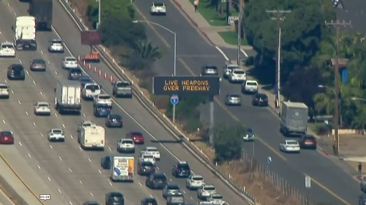LIVE WEAPONS OVER FREEWAY SIGN