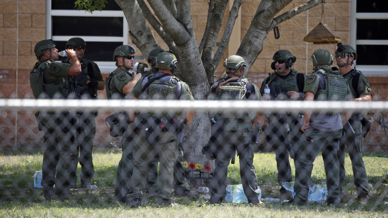 Law enforcement personnel stand outside Robb Elementary School following a shooting