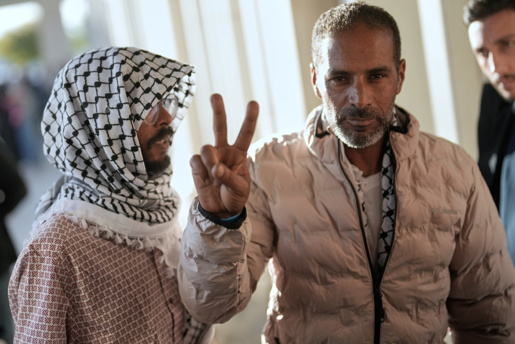 Activists from the Global Sumud Flotilla give the peace sign after arriving at Istanbul Airport in Istanbul, Turkey.