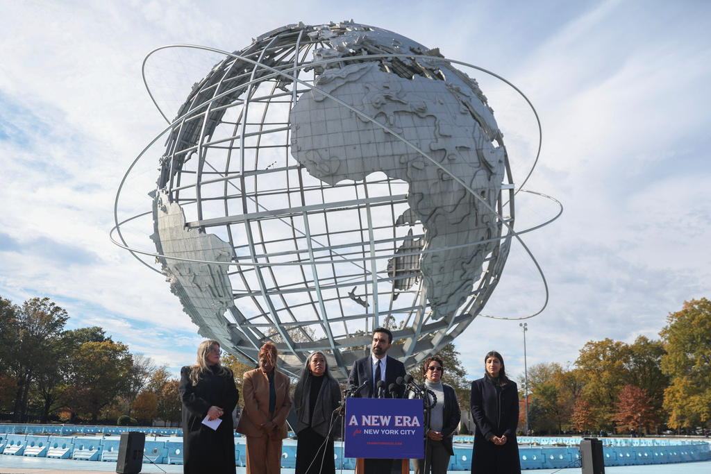 New York City mayor-elect Zohran Mamdani, center, speaks in front of the Unisphere alongside his transition team in the Queens borough of New York, Wednesday, Nov. 5, 2025.