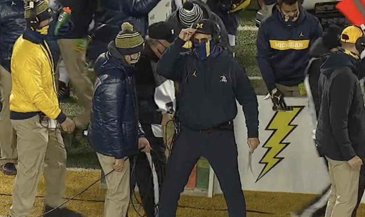 Harbaugh wears blue pants, telling Brad Galli, "You don't want to become like stale bread"